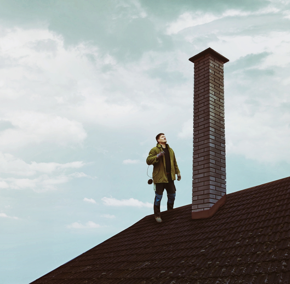 man and woman laughing while sitting in front of laptops